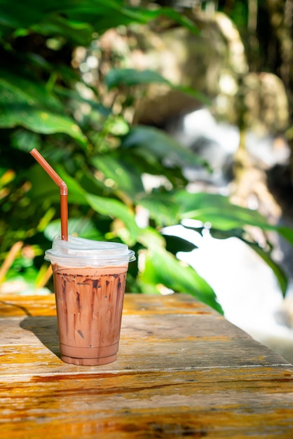 Iced chocolate milkshake on table