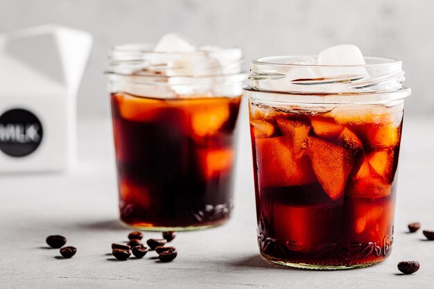 Iced Coconut Chai Tea Latte in glass jar on gray stone background