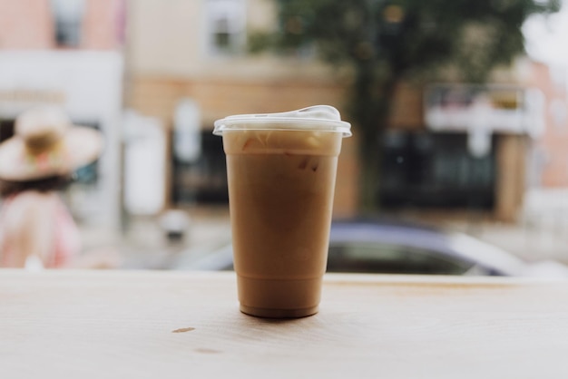 Iced Coffee Drink in a Disposal Plastic Cup Standing on a Table