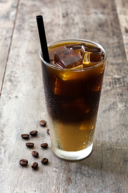 Iced coffee in glass on wooden table