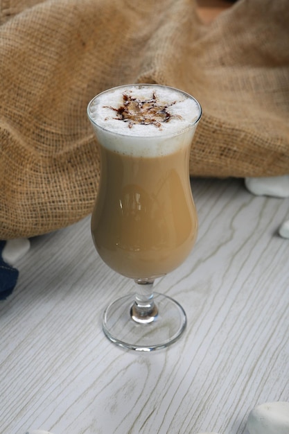 Iced coffee with milk Iced coffee latte  Woman holding glass cup of iced coffee