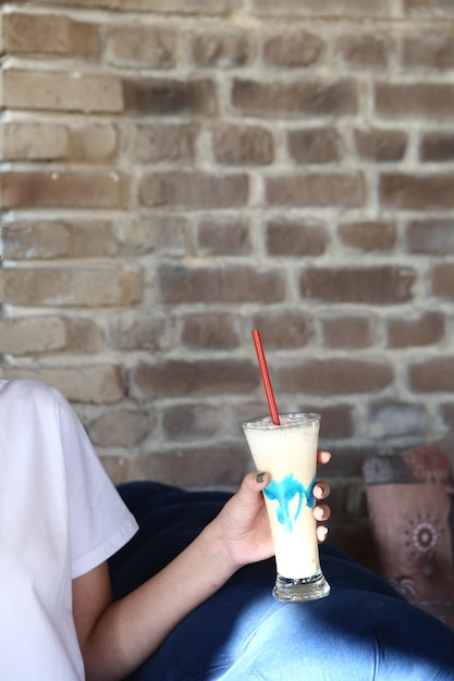 Iced coffee with milk Iced coffee latte  Woman holding glass cup of iced coffee