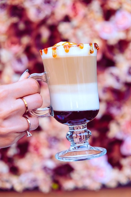 Iced coffee with milk. Iced coffee latte . Woman holding glass cup of iced coffee.