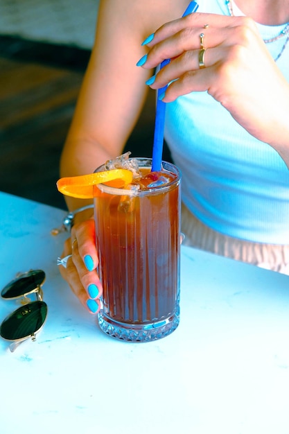 Iced coffee with milk Iced coffee latte Woman holding glass cup of iced coffee