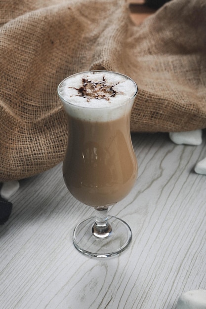 Iced coffee with milk. Iced coffee latte . Woman holding glass cup of iced coffee.