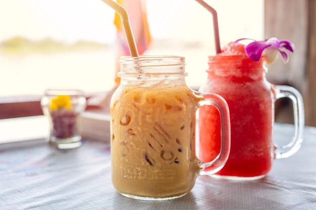 Iced coffee with water melon ice frappe on wooden table for fresh cold summer drinks