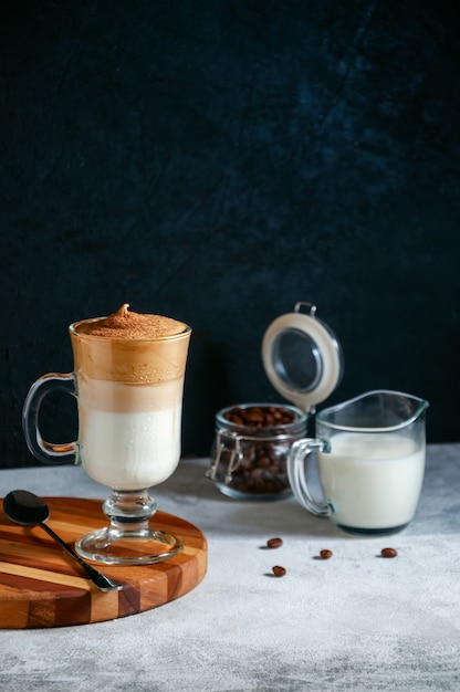 Iced Dalgona coffee in a glass on dark background