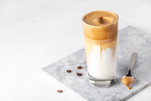 Iced fluffy creamy whipped trend drink with coffee foam and milk