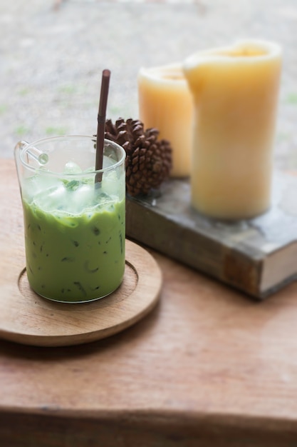 Iced green tea latte on wooden table