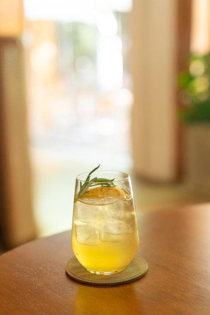 iced lemon honey glass with rosemary in cafe restaurant