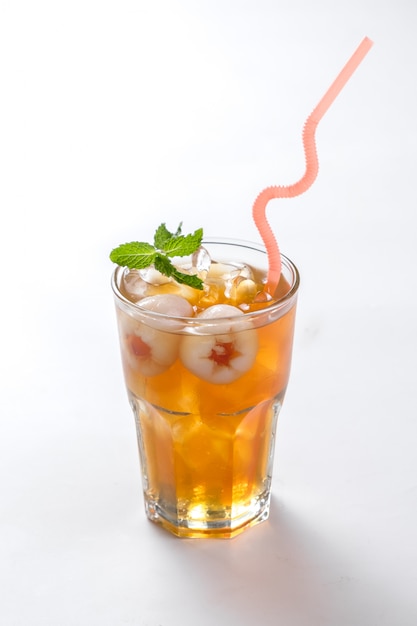 Iced Lychee Tea with Straw and Mint Leaves