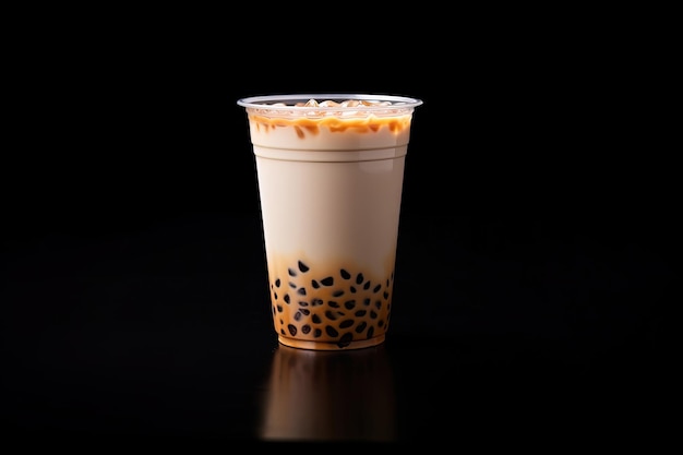 iced milk tea and bubble boba in the plastic glass on the dark background