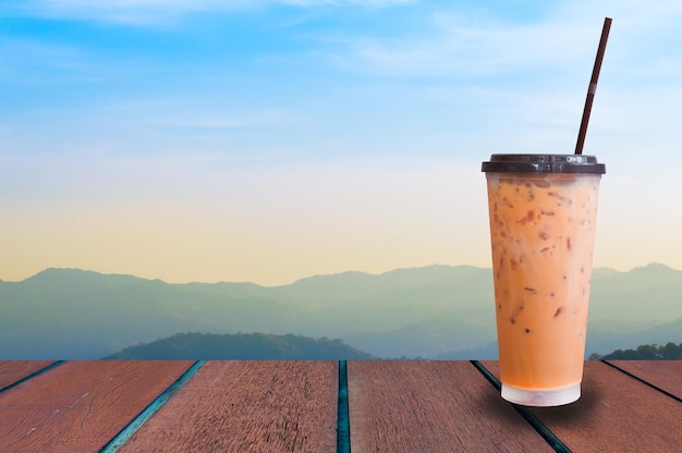 Iced milk tea on nature background Summer drinks with ice
