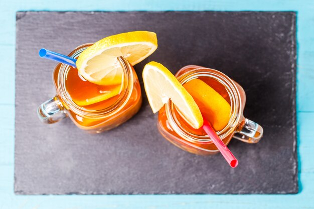 Iced tea in a glass jar with lemon.