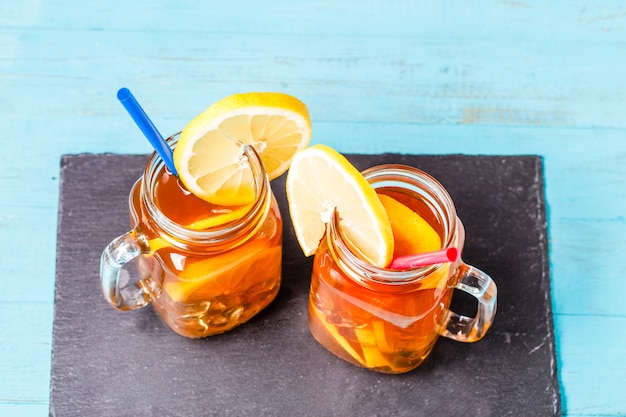 Iced tea in a glass jar with lemon.