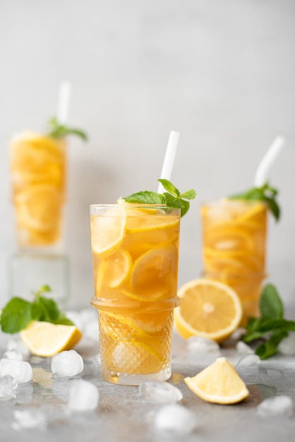 Iced tea with lemon and ginger in glasses