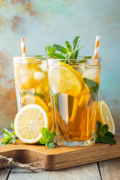 Iced tea with lemon and ice in tall glasses.