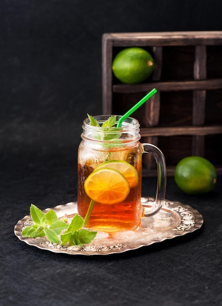 Iced tea with lime in a glass jar