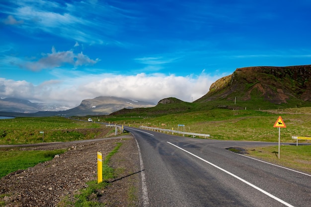 Iceland landscape with empty road mountains and cloudy sky Travel adventure scandinavian concept