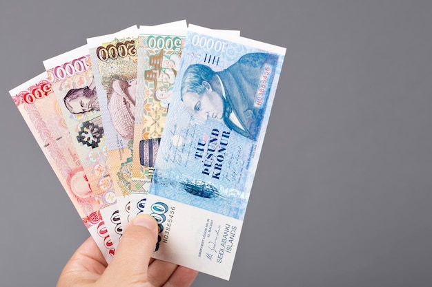 Icelandic money in the hand on a gray background