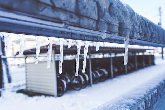 Icicle is hanging from a roof