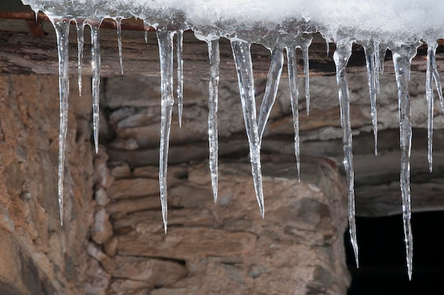icicle on stone wall in winter time