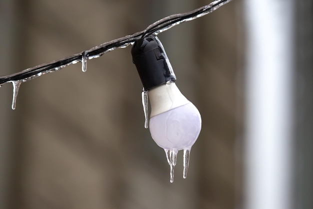 Icicles on frozen street lighting lamps winter weather season street interior details object of electricity