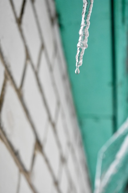 Icicles hang from the roof of the house