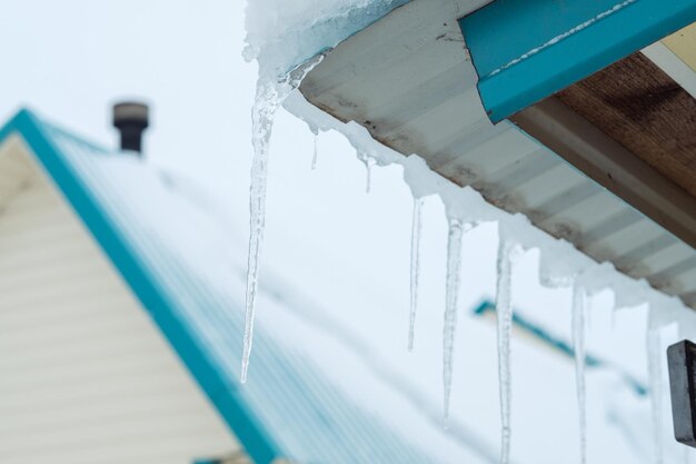 Icicles hang on the roof Danger in winter