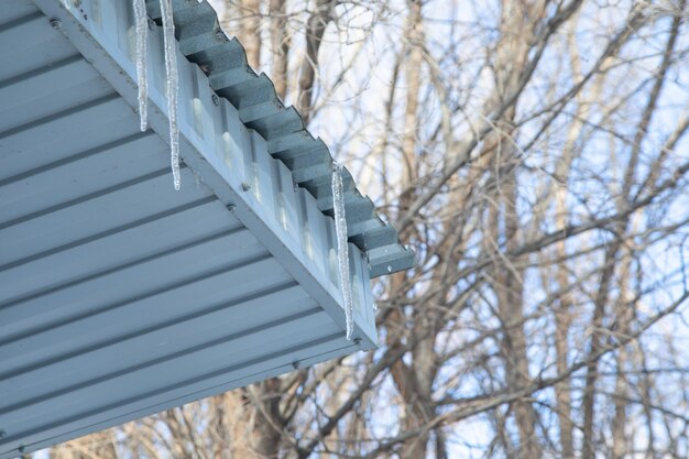 Icicles on house roof in cold winter