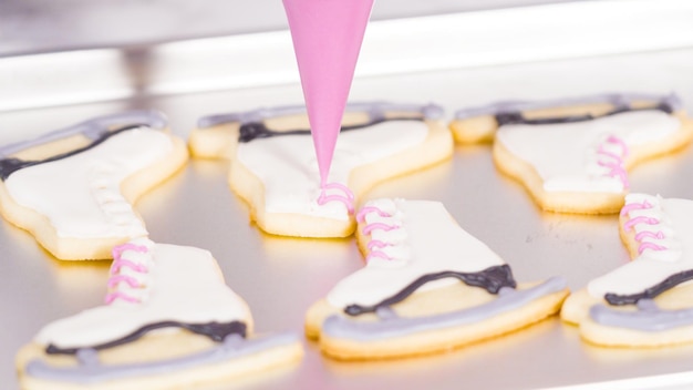 Photo icing figure skate shaped sugar cookies with royal icing.