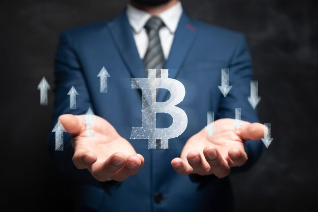 Icon of bitcoin and arrows up and down from the network Man holding in his hand