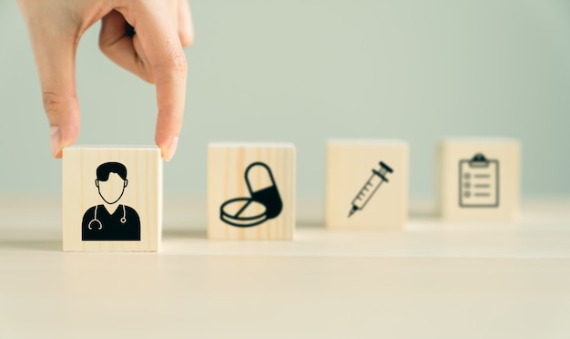 Icon healthcare and medical on wood block stacking on the table, Health Insurance Concept.