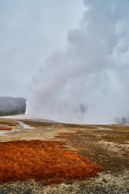 Iconic geyser old faithful going off at yellowstone in winter
