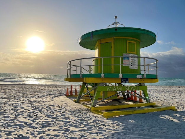 Iconic green lifeguard house in Miami Beach Beautiful blue sky at sunrise