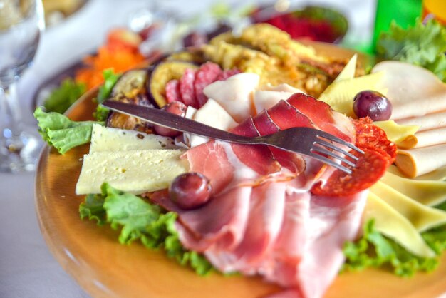 icture of a Snack with delicious salami on a wood platter