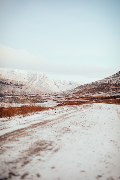 An icy road near mountains in Iceland during wintertime