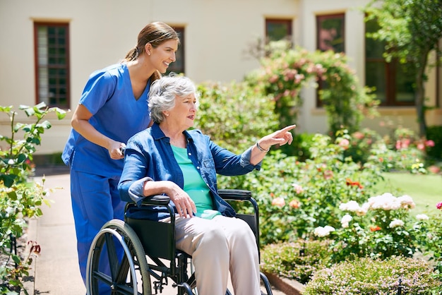 Photo id like to go that way shot of a resident and a nurse outside in the retirement home garden