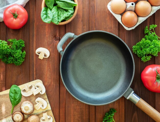 Idea for breakfast empty castiron frying pan and ingredients for omelette or scrambled eggs eggs mus