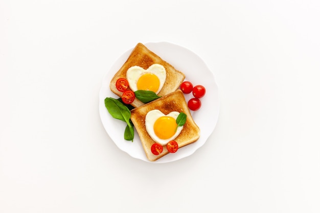 Idea for the celebration of Valentine's day: breakfast - toast with scrambled eggs in the form of hearts