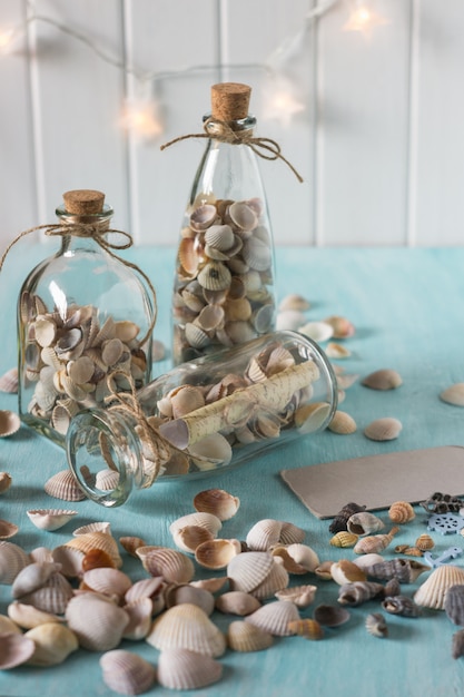 Idea of interior decoration with seashells and glass bottles. Marine concept.