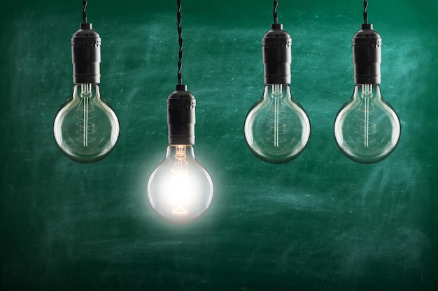 Idea and leadership concept vintage bulbs on wall background