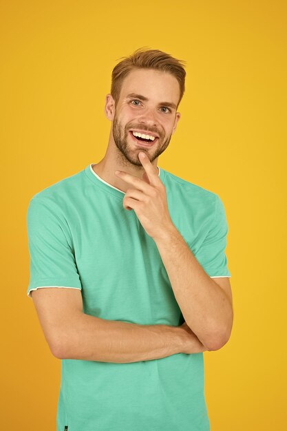 Idea male beauty barber hairdresser salon handsome bearded man something on his mind handsome man thinking yellow background well groomed handsome guy with bristle and stylish hairstyle