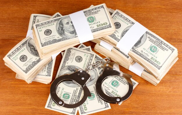 Idea of punishment for financial fraud on wooden background