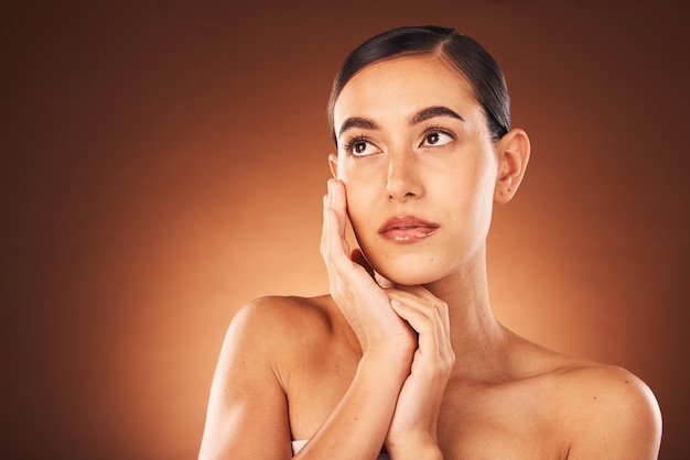 Photo idea skincare and woman with beauty makeup spa wellness and self love glow against a brown studio background cosmetics marketing and thinking model with luxury cosmetic care and dermatology