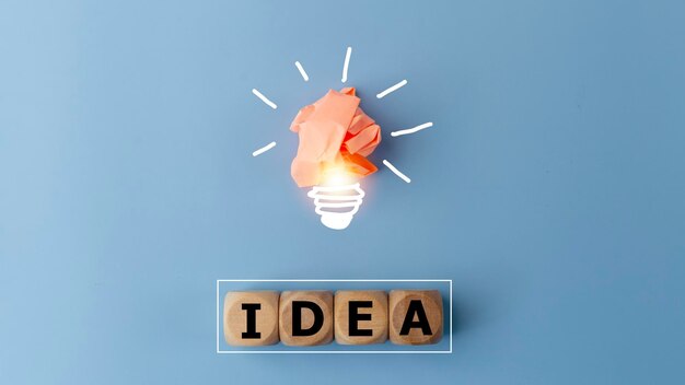 Photo idea word and light bulb on blue background with copy space creative thinking ideas and innovation concepts