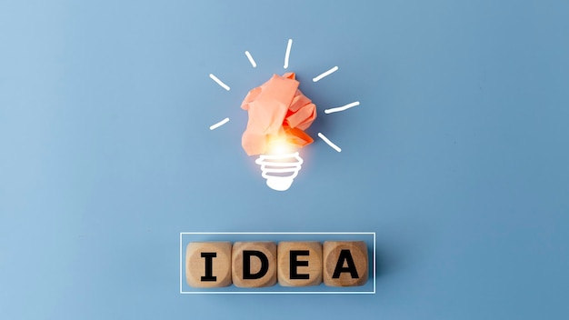 Idea word and light bulb on blue background with copy space Creative thinking ideas and innovation concepts