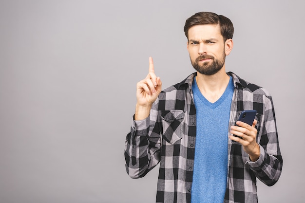 Idea! Young stylish hipster guy raises index finger