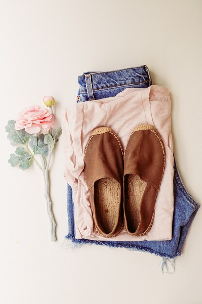 Ideal clothes for summer outfits: a shirt, jeans, shoes. View from above.