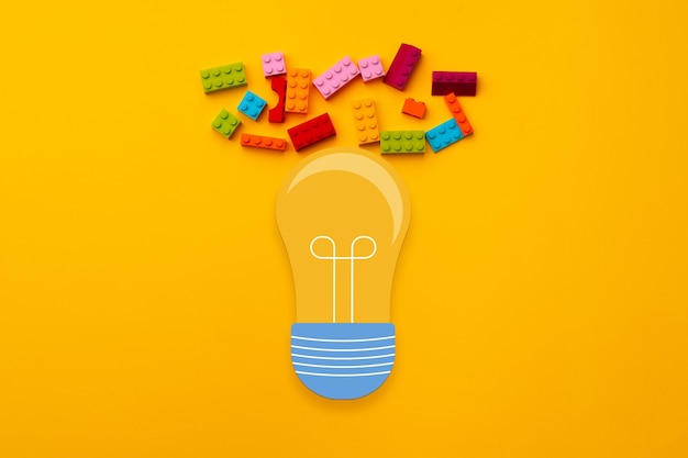 Photo ideas concept with light bulb and toy constructor details